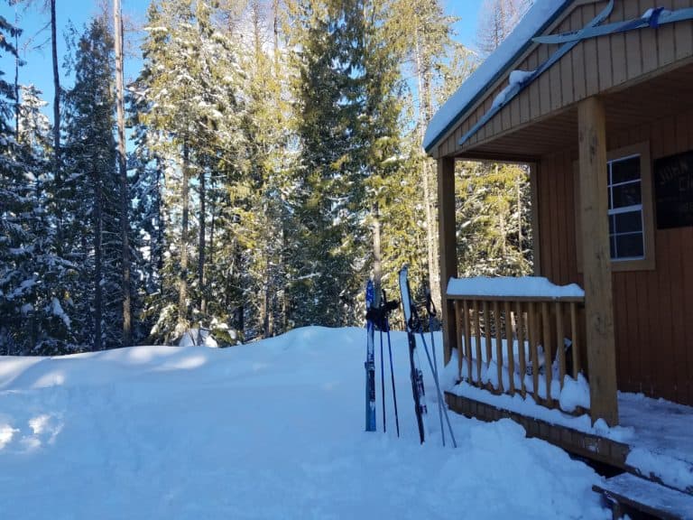 snow outside cabin with skis and poles | the DAWN Method