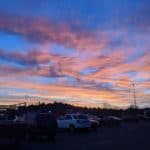 Parking lot with cars and trucks with sunset